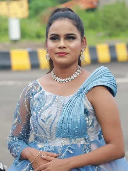 A close-up of another student's work, featuring a soft blue eyeshadow that matches the gown's embroidery.