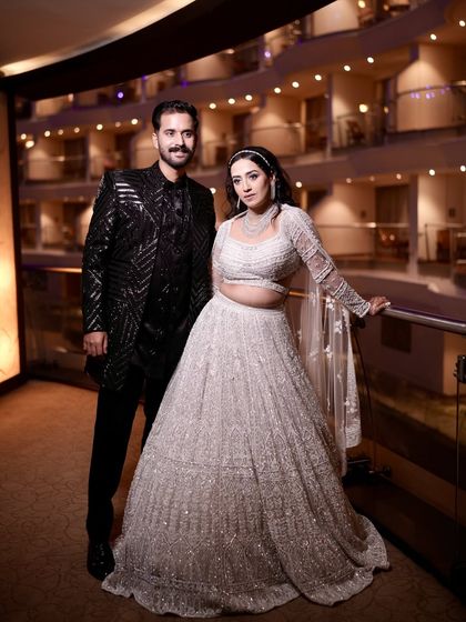 A full-length shot of the couple. The bride's showstopper look was both grand and perfectly suited to her personality.