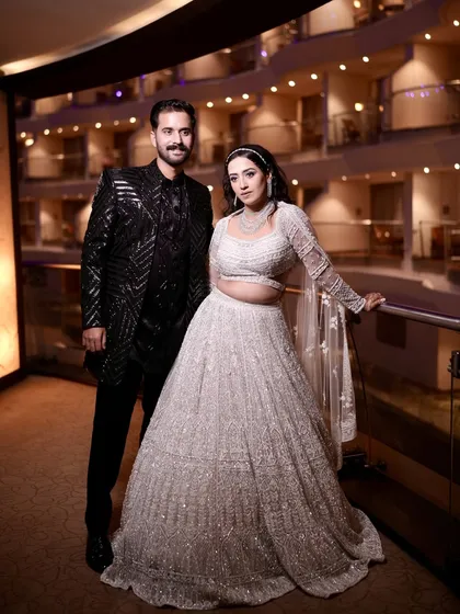 A full-length shot of the couple. The bride's showstopper look was both grand and perfectly suited to her personality.