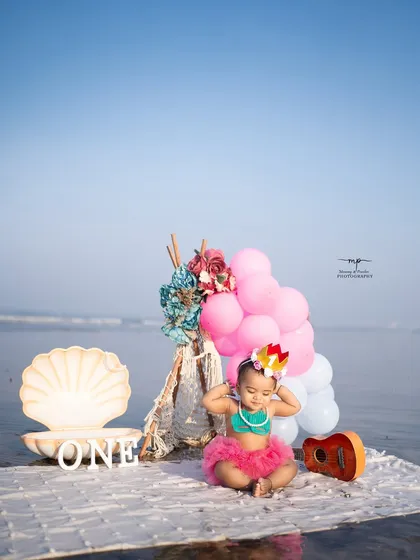 A playful moment from the mermaid-themed birthday shoot, as the little one adjusts her crown. This candid shot captures her personality and the fun of the session.