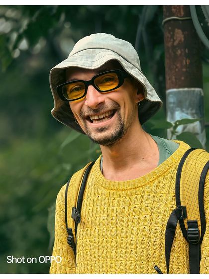 The bright smile of a man I met on my travels, captured in a candid moment. His yellow sweater and bucket hat add to the cheerful and friendly nature of this stranger portrait.