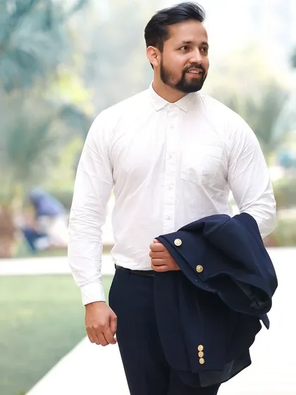 A casual and confident shot of the groom. This relaxed portrait shows a different side of his personality.