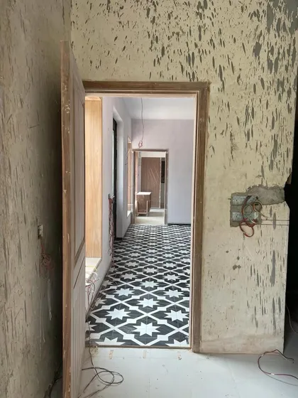 Every restoration begins with a conversation between what was and what will be. Here, you see the journey unfolding. The raw, textured walls hold the memory of the past, while the newly laid geometric tiles signal the start of a new chapter. This is the beautiful, messy process of bringing a story back to life.