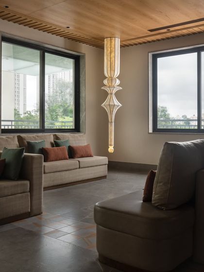 The VIP lounge offers a quiet, comfortable retreat. We selected elegant sofas and a stunning, sculptural pendant light to create a refined and private space for guests.