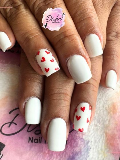 Our POV: Love is on the nails. A simple and cute design with a classic white base and tiny red hearts.