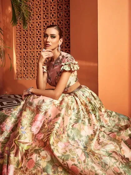 Styled for a Wedding Asia campaign, this image features a breathtaking floral lehenga by designer Rocky Star. The setting and pose are designed to evoke a sense of spring regalia, perfectly pairing the voluminous skirt with exquisite diamond jewelry.
