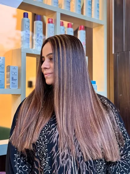 A side profile of the golden blonde highlights, showing how they add brightness and dimension to long, straight hair.