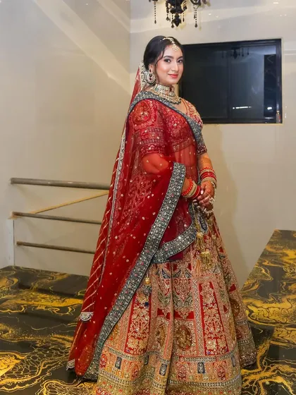 Another full-length shot, this time on a luxurious marble floor, highlighting the grandeur of her bridal look.