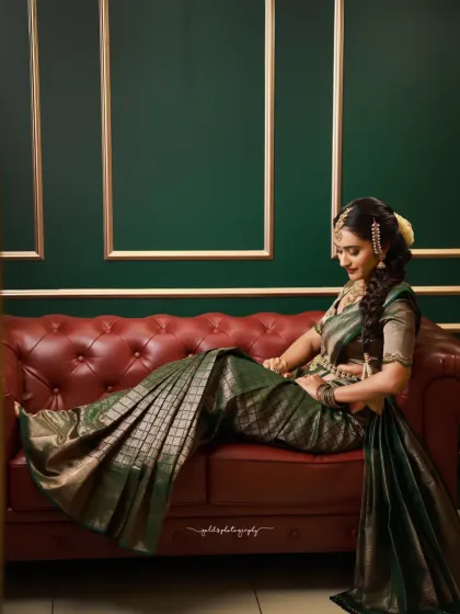 Indoor portraits of a model in a dark green silk saree. The elegant posing, reflection in the mirror, and studio setup with a classic red sofa create a sophisticated and polished look.
