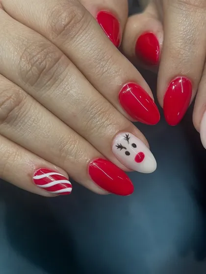 A cute Christmas set featuring a reindeer accent nail and candy cane stripes.