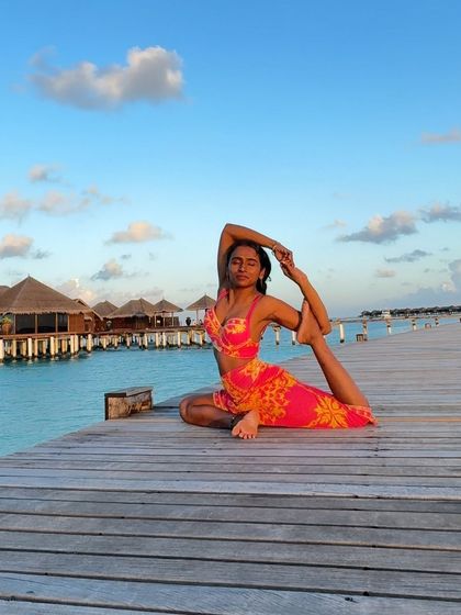 A photo dump from the Maldives, featuring a beautiful Eka Pada Rajakapotasana (One-Legged King Pigeon Pose) on a pier.