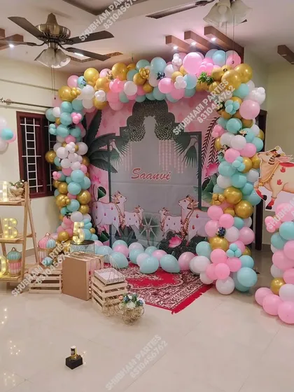 A unique and traditional Pichwai theme featuring cow illustrations on the backdrop, surrounded by a pastel balloon arch.