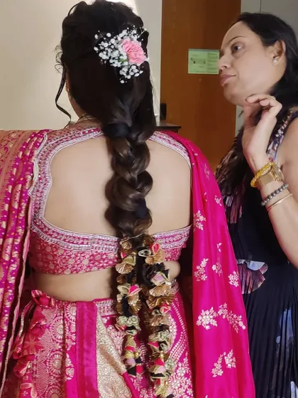A look at the back of Gunjan's hairstyle, a beautiful thick braid adorned with a traditional paranda, perfect for her Gujarati outfit.
