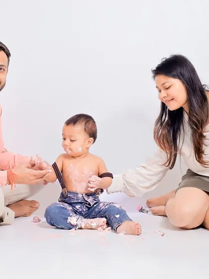 Parents joining in on the fun. A cake smash session is a memorable experience for the entire family, and I make sure to capture these interactive moments.