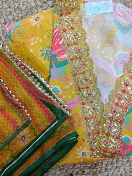 Brighten up your wardrobe with this yellow floral cotton suit piece. It comes with a heavily embroidered neckline and a contrasting printed dupatta.
