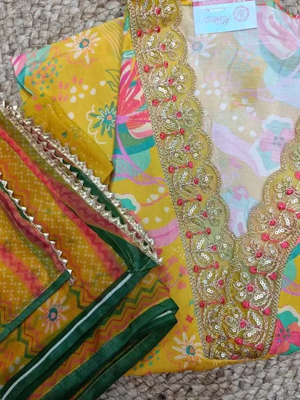 Brighten up your wardrobe with this yellow floral cotton suit piece. It comes with a heavily embroidered neckline and a contrasting printed dupatta.