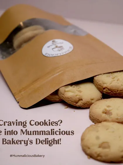 Craving cookies? Our freshly baked white chocolate chip cookies are spilling out of a packet, ready to be enjoyed. They have the perfect soft and chewy texture.