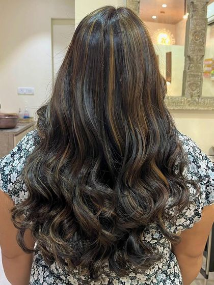 This is a global hair color with added highlights for depth. The combination of an all-over color with strategically placed lighter pieces creates a rich, dimensional look that is perfect for adding volume and interest to long hair.