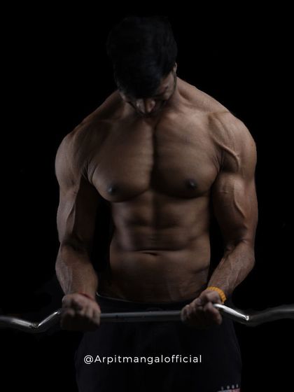 Isolating the Biceps. A photo demonstrating a barbell curl with intense focus, highlighting the importance of controlled movements in strength training.