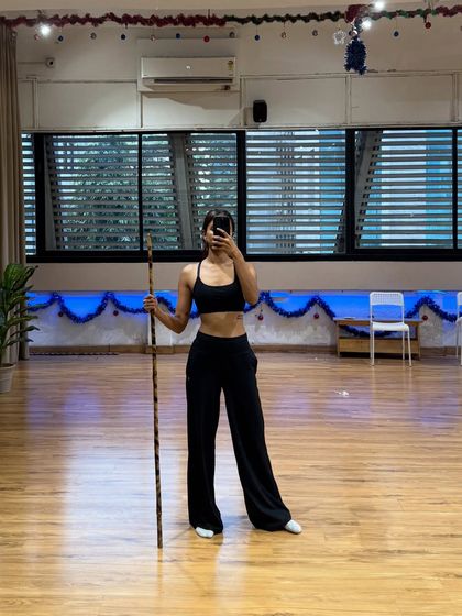 A studio selfie with a prop stick, feeling strong and ready to create. Ending the year dancing until I drop, and ready to start the new one the same way.