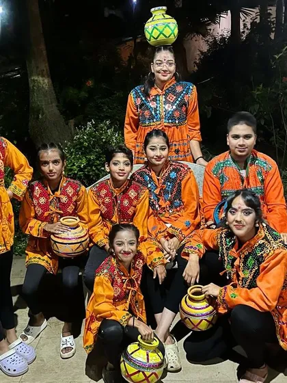 Teamwork makes the dream work. Our folk dance troupe is ready for showtime, complete with colorful costumes and traditional props. We train for performances that honor our culture.