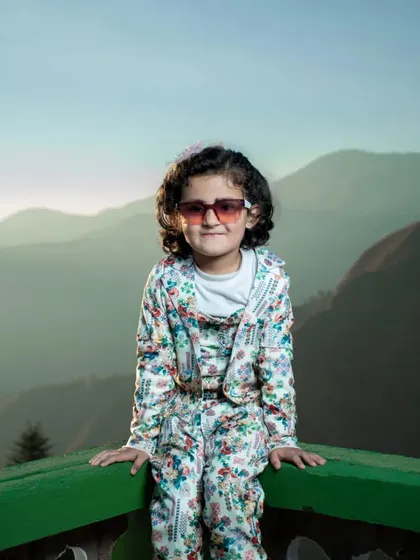 A fun and fashionable shot of my daughter on a balcony overlooking the mountains. Outdoor kids photoshoots like this use the epic scenery of Himachal as a natural studio.