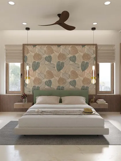 This bedroom design is light, airy, and connected to nature. The leaf-patterned wallpaper behind the bed serves as a beautiful focal point, complemented by hanging pendant lights and light wood furniture.