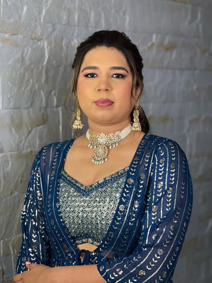 A full view of the pearl-based choker set on a client. The matching jhumka-style earrings complete the look, making it a perfect rental for a sangeet or mehndi function.