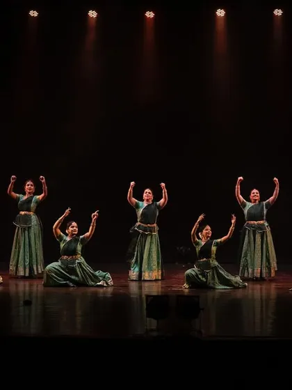 The full cast of 'Ek Anant' on stage with the live orchestra. This image captures the scale of the production and the collaboration between dancers and musicians.
