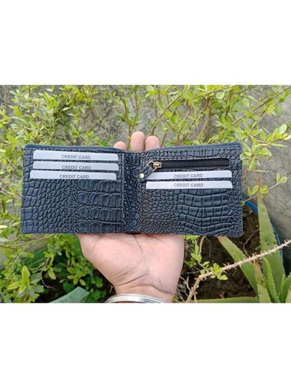 A look inside the crocodile leather wallet, showing its ample card slots and zippered coin compartment.