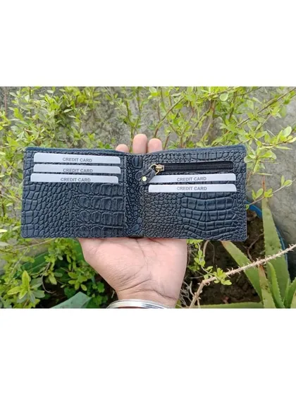 An open view of the black crocodile leather wallet, displaying its ample storage with multiple card slots and a zippered coin compartment.