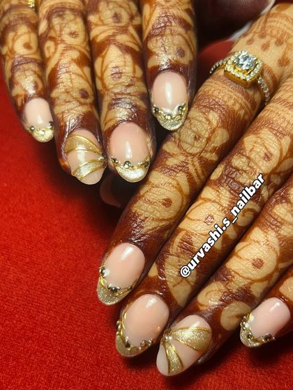 Here’s another stunning option for an engagement. The soft nude base is the perfect canvas for these sculpted gold accents and delicate gem placements, creating a look that is both traditional and modern.