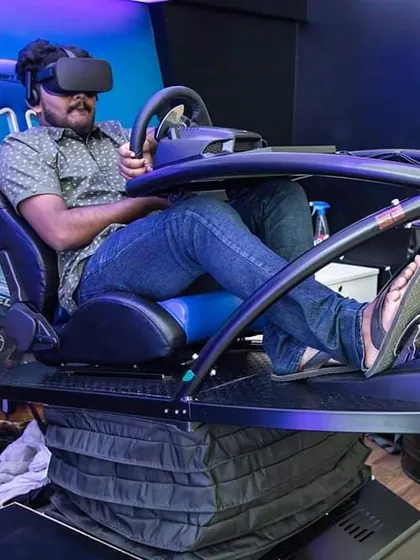 A guest experiences the thrill of our VR driving simulator. The professional-grade racing seat and motion platform provide haptic feedback, simulating every turn and bump for a truly immersive motorsport experience at your event.