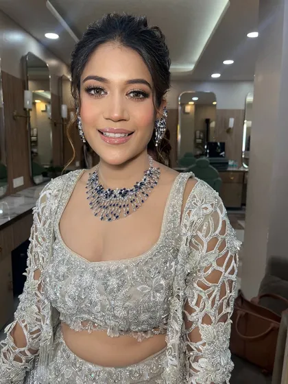 A soft glam look for this client in a beautiful silver lehenga. The makeup is understated and elegant, perfect for a sophisticated event.