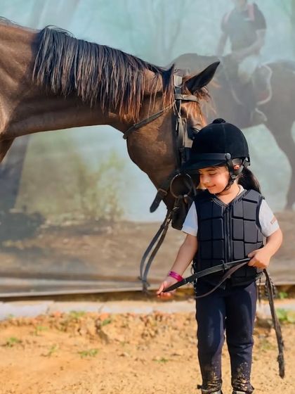 A child gently leads her horse, showing the trust and respect we nurture between our riders and animals.