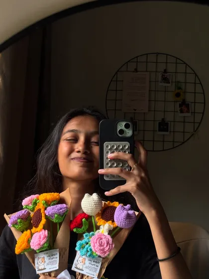 This is me in my natural habitat, surrounded by yarn and chaos. I whipped up these colorful crochet flower bouquets in just 24 hours for a rush order. Each bouquet is unique, featuring a mix of flowers like sunflowers, tulips, and roses that will never wilt. 💐