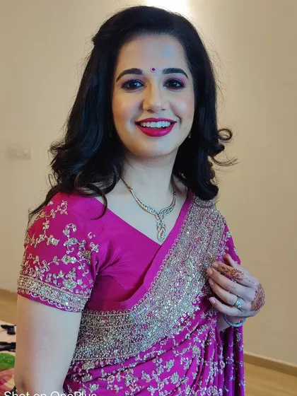 The final look for Priyanka. I gave her classic, soft curls, a bright red lipstick, and defined eyes that make her shine. She looks absolutely ready for her party.