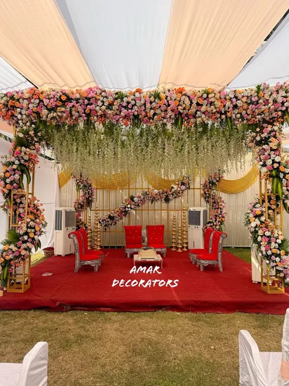 For this outdoor wedding, I designed a breathtaking floral mandap that felt both grand and natural. The canopy is lush with pastel roses and hanging white wisterias, creating the perfect sacred space for pheras under the open sky.