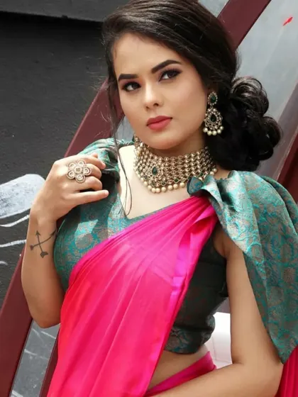 A modern party look with a designer saree and blouse, paired with antique-style jewellery.