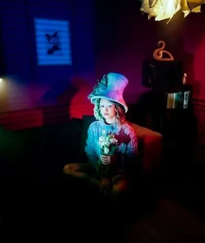 An experimental shoot with a whimsical theme. The makeup is kept soft to work with the colorful, multi-hued lighting and quirky styling of the scene.
