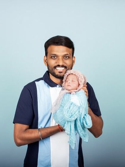 A proud father holds his newborn baby for the first time in the studio. Capturing these early moments of bonding is one of the most rewarding parts of my job.
