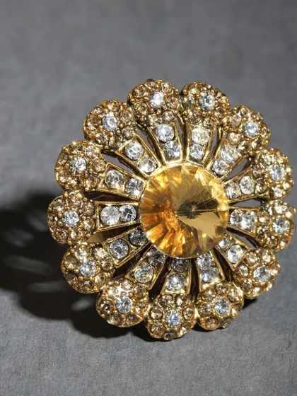 Another stunning floral-designed adjustable ring with a central yellow stone.