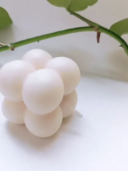 A simple, elegant shot of the white soy wax bubble candle. Its clean form and smooth texture make it a versatile piece that fits into any decor style, from modern to classic.