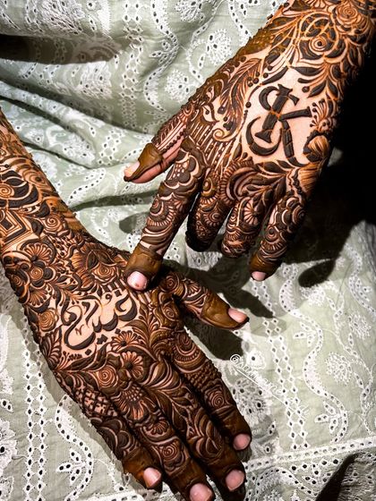 A beautiful composition showing both hands, one with the initial 'K' and the other with a name in script, demonstrating the versatility of my custom designs.