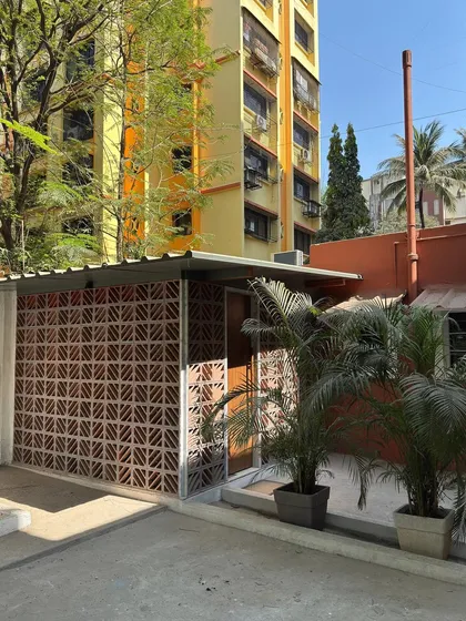 This is the exterior of our studio extension in Mumbai, built using a terracotta brick jali. This feature filters the harsh sun to create soft, changing light patterns, showcasing our commitment to using indigenous, locally sourced materials in a modern context.