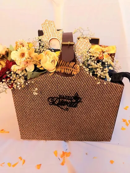 A floral-forward Diwali hamper for someone who loves elegant decor. This basket is overflowing with flowers, a personalized 'Happy Diwali' nameplate, and a curated selection of gourmet snacks and a sipper.