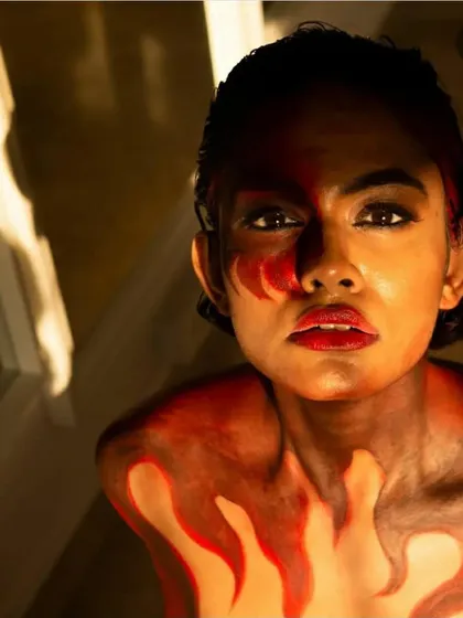 For this project, I used the model's body as a canvas to create a fiery, abstract look. This is an example of the experimental body painting I do for artistic shoots and campaigns.