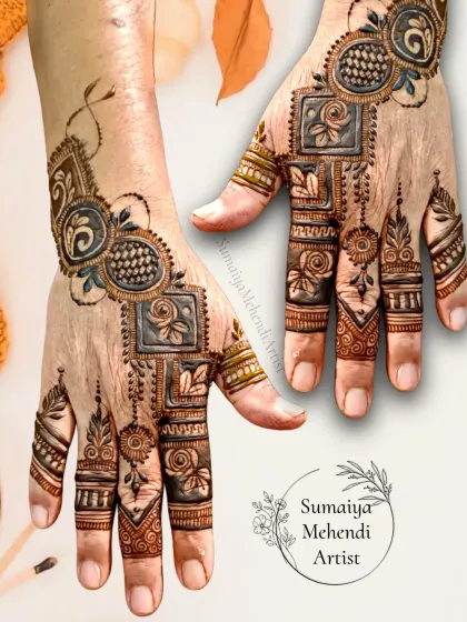 A unique Eid henna design I did for my mom, featuring bold, shaded squares and floral motifs.