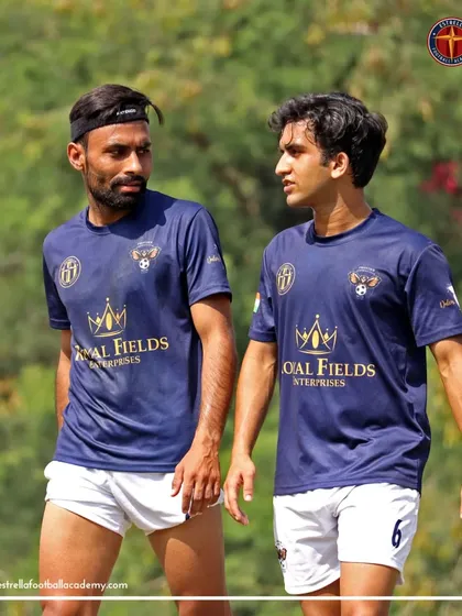 Two of my senior players in discussion during a break in an A Division league match. On-field communication and strategy are vital.