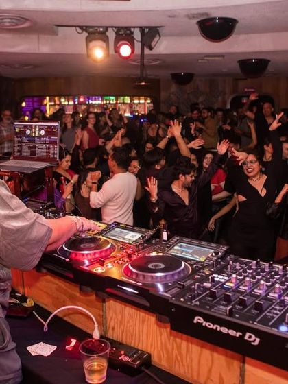 Me, behind the decks at the Bolliday Edition of Bollywood Disco. I love spinning my favorite retro filmi tracks and seeing the joy on the dance floor.